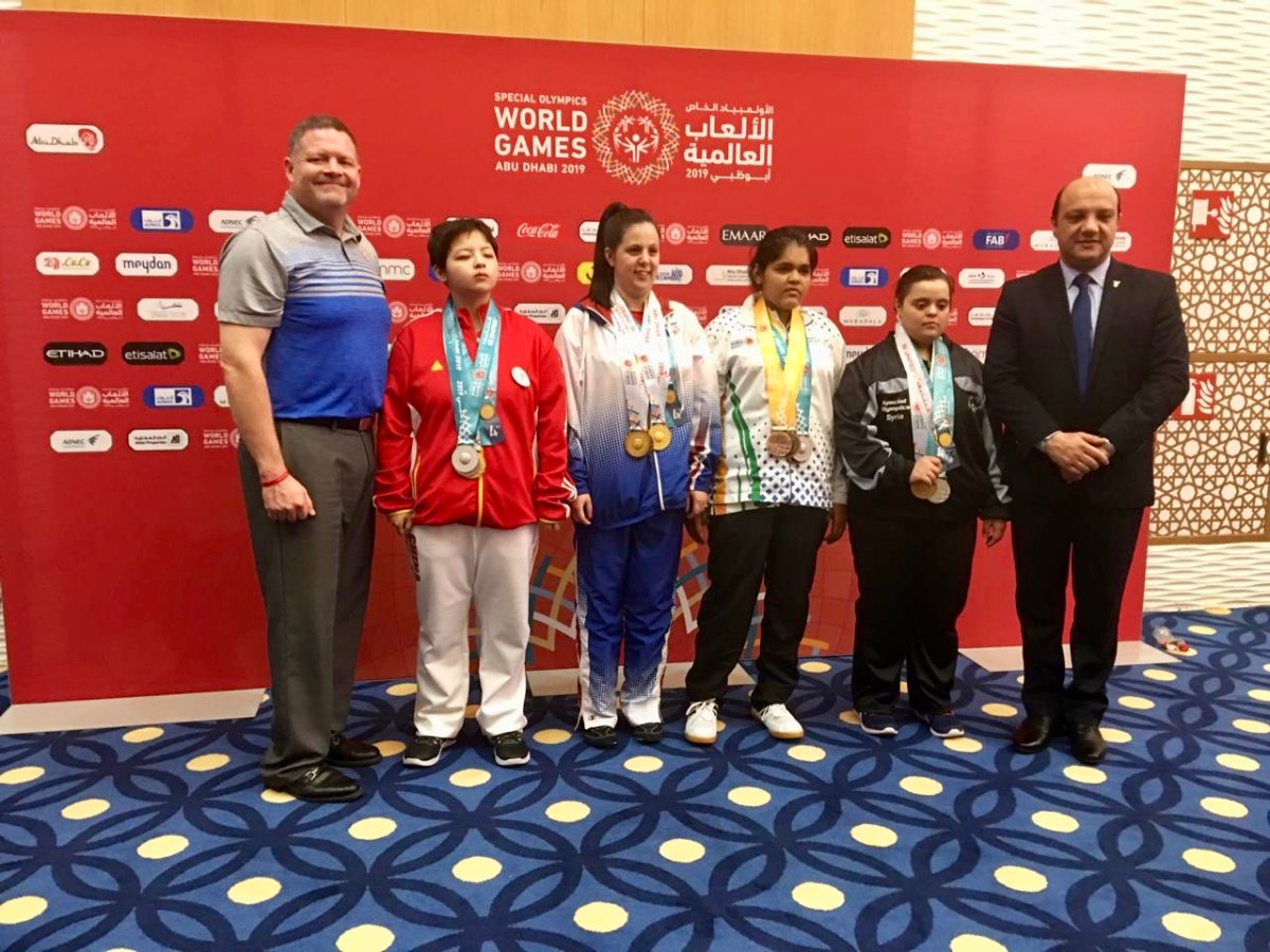 Darrell Seale with medal-winning athletes at the Special Olympics World Games Abu Dhabi 2019